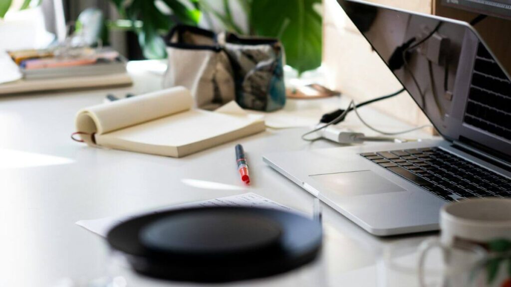 Difference Between Doing SEO for Affiliate Sites and Doing SEO for Your Own Business (2026 Guide) Laptop and notebook on desk representing affiliate SEO vs business SEO strategy comparison 2026